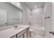 Well-lit bathroom featuring a single vanity, shower-tub combo and neutral tiling at 307 Dunlin Pl, Conway, SC 29526