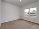 Neutral bedroom with plush carpeting, a double window, and ample natural light at 307 Dunlin Pl, Conway, SC 29526