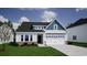 New construction exterior elevation with white siding, brick accents and an attached two car garage at 307 Dunlin Pl, Conway, SC 29526