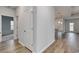 Hallway leading to the kitchen, with wood-look flooring and an open design at 307 Dunlin Pl, Conway, SC 29526