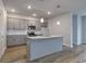 Bright kitchen features gray cabinets, stainless steel appliances, granite counters, and an island with pendant lighting at 307 Dunlin Pl, Conway, SC 29526