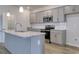 View of gray kitchen featuring stainless appliances, island, granite counters, and walk in pantry at 307 Dunlin Pl, Conway, SC 29526