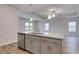 Kitchen island with sink and dishwasher features granite countertops, pendant lighting, and gray cabinets at 307 Dunlin Pl, Conway, SC 29526