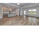 Open living space showcases the kitchen, stainless appliances, granite countertops, gray cabinets and wood-look floors at 307 Dunlin Pl, Conway, SC 29526