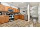 Well-equipped kitchen features stainless steel appliances, warm wood cabinetry, and spacious layout at 310 Kiskadee Loop # D, Conway, SC 29526