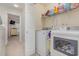 Practical laundry room with washer, dryer, and shelving for storage, conveniently located near the bedroom at 310 Kiskadee Loop # D, Conway, SC 29526