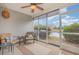 Relaxing screened porch with comfortable seating, ceiling fan, and serene views of the lake at 310 Kiskadee Loop # D, Conway, SC 29526