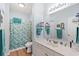 Well-lit bathroom with a vanity, framed mirror, and shower with stylish turquoise wave design shower curtain at 3104 Sweetwater Blvd. # 3104, Murrells Inlet, SC 29576