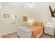 A bedroom is bathed in light, featuring white wicker furniture, neutral colored walls, and ample closet space at 3104 Sweetwater Blvd. # 3104, Murrells Inlet, SC 29576