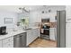 Modern kitchen featuring white cabinets, stainless steel appliances, and an adjacent breakfast nook for casual dining at 3104 Sweetwater Blvd. # 3104, Murrells Inlet, SC 29576