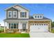 Charming two-story home with a mix of stone and siding, complemented by a well-manicured lawn at 311 Dunlin Pl, Conway, SC 29526