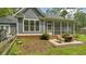 Backyard featuring patio with seating, screened in porch, and mature trees and landscaping at 3180 Long Avenue Ext., Conway, SC 29526
