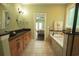 A bathroom features a double sink vanity and a soaking tub with tile surround at 3180 Long Avenue Ext., Conway, SC 29526