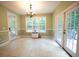 Bright dining area with tiled floor and doors that lead to a backyard deck at 3180 Long Avenue Ext., Conway, SC 29526