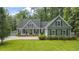 Charming home featuring blue siding, black shutters, and a well-manicured lawn at 3180 Long Avenue Ext., Conway, SC 29526