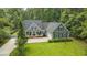 Aerial view of the home showcasing its charming facade and lush surrounding greenery at 3180 Long Avenue Ext., Conway, SC 29526