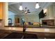 View of living room from kitchen, showcasing the stone fireplace and tray ceilings at 3180 Long Avenue Ext., Conway, SC 29526