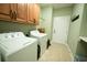 Dedicated laundry area with a washing machine and dryer, complete with wall cabinets at 3180 Long Avenue Ext., Conway, SC 29526