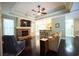 Cozy living room with a stone fireplace, hardwood floors, and open access to the kitchen at 3180 Long Avenue Ext., Conway, SC 29526