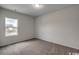Cozy carpeted bedroom with a window showing a glimpse of the outdoors at 331 Garden Grove St, Conway, SC 29526