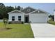 Charming single-story home with a well-manicured lawn and attached garage at 331 Garden Grove St, Conway, SC 29526