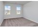 Bedroom featuring neutral walls, carpeting, and two windows at 335 Garden Grove St, Conway, SC 29526