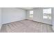 Bedroom with neutral walls, carpet, and natural light from two windows at 335 Garden Grove St, Conway, SC 29526