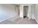 Neutral bedroom has carpeted floors with an open closet and a door to another room at 335 Garden Grove St, Conway, SC 29526