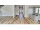 Hallway showcasing plank flooring, neutral walls, and doorways leading to different rooms at 335 Garden Grove St, Conway, SC 29526