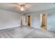 Large main bedroom with plush carpet, neutral walls, and access to ensuite bathroom and walk-in closet at 335 Garden Grove St, Conway, SC 29526