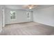 Spacious main bedroom boasts plush carpeting and two windows offering ample natural light at 335 Garden Grove St, Conway, SC 29526