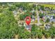 Aerial view of neighborhood and a home denoted by a red map pin, lush trees surround the property at 340 Boxcar Dr., Longs, SC 29568