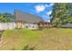 Backyard with lawn, perimeter fence and an outdoor patio structure at 340 Boxcar Dr., Longs, SC 29568