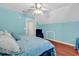 Bright bedroom featuring blue walls, ceiling fan and a cozy blue accent chair at 340 Boxcar Dr., Longs, SC 29568