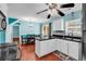 Open kitchen with stainless steel sink, wooden floors, white cabinets, and a dining area at 340 Boxcar Dr., Longs, SC 29568