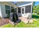 Outdoor patio area with a covered grill and white chairs, ideal for entertaining guests at 359 Harbour Reef Dr., Myrtle Beach, SC 29588