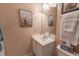 Bright bathroom featuring a white vanity, framed artwork, and a decorative mirror at 359 Harbour Reef Dr., Myrtle Beach, SC 29588