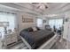 Spacious main bedroom features a large bed, tray ceiling, ceiling fan, and a decoratively framed bridge print at 359 Harbour Reef Dr., Myrtle Beach, SC 29588