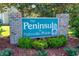 The Peninsula at Palmetto Pointe brick community sign with lush landscaping beneath it at 359 Harbour Reef Dr., Myrtle Beach, SC 29588