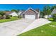 A view of the home's exterior showcasing its vinyl siding and the driveway leading to the attached garage at 359 Harbour Reef Dr., Myrtle Beach, SC 29588