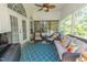Relaxing screened porch with comfortable seating, a ceiling fan, and views of nature at 359 Harbour Reef Dr., Myrtle Beach, SC 29588