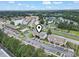 Scenic aerial view of a well-maintained residential community with a swimming pool, pond, and ample parking at 3676 Clay Pond Village Ln. # 4, Myrtle Beach, SC 29579