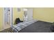 Bedroom with yellow walls and open doorway to another room showing the natural light at 3676 Clay Pond Village Ln. # 4, Myrtle Beach, SC 29579