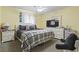 Bright bedroom with sunny yellow walls, plaid bedding, and crisp white furniture at 3676 Clay Pond Village Ln. # 4, Myrtle Beach, SC 29579