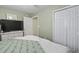Bedroom with neutral green walls and bright white trim with a large window and closet at 3676 Clay Pond Village Ln. # 4, Myrtle Beach, SC 29579