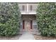 Close up of a charming condominium entrance with brick and white trimmed balcony above at 3676 Clay Pond Village Ln. # 4, Myrtle Beach, SC 29579