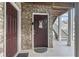 Welcoming condo doorway with brick facade, wood beams, and stairway leading to upper level at 3676 Clay Pond Village Ln. # 4, Myrtle Beach, SC 29579