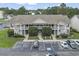 Two-story condo with white staircases and lush green landscaping in a well-maintained complex at 3676 Clay Pond Village Ln. # 4, Myrtle Beach, SC 29579