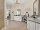 Bright bathroom featuring double vanities, granite countertops, decorative mirrors, and a stunning chandelier at 3736 Kingsley Dr., Myrtle Beach, SC 29588