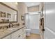 Well-lit bathroom featuring a granite countertop vanity, framed mirror, and a shower-tub combination at 3736 Kingsley Dr., Myrtle Beach, SC 29588